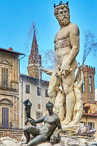 Neptune statue on the Neptune fountain in Florence from behind. The Fountain of Neptune is situated in the Piazza della Signoria in front of the Palazzo Vecchio. The fountain was commissioned by Cosimo I de' Medici in 1559.