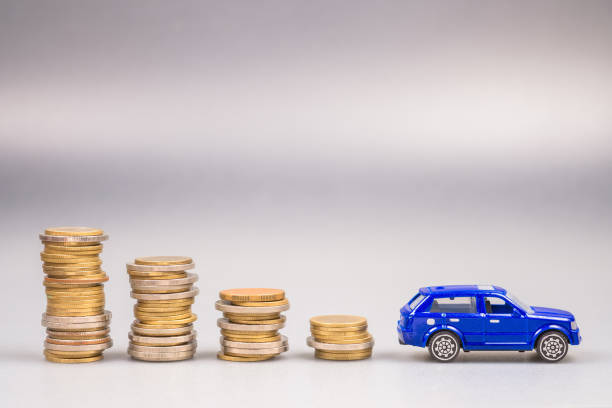 Save the money for buying a new car Lower stack money with a small blue car at the end, save the money for buying a new car, car and budget, finance and insurance, use money less about the car cash for cars stock pictures, royalty-free photos & images