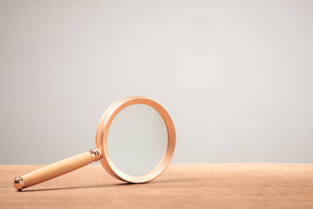 istock Magnifying glass on wood table 1440513966
