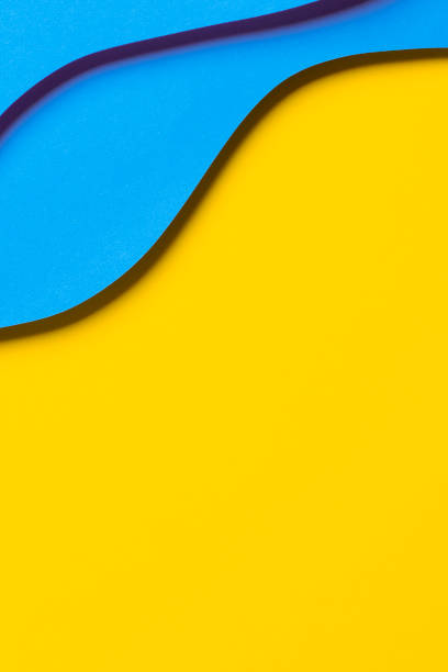 istock Abstract colored paper texture background. Minimal paper cut style composition with layers of geometric shapes and lines in light blue colors on yellow background. Top view 1440513993