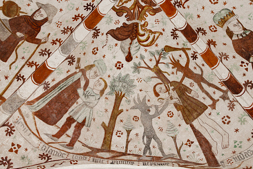A recovered ancient fresco on display at the Aarhus Cathedral in Denmark, used to educate people who could not read, depicting the Christian concept of heaven, earth and hell, top to bottom. \nAarhus Cathedral's walls were originally covered with murals, but during the Reformation, they were whitewashed. Gradually several of the paintings have been been uncovered. Despite the loss, it is the church in Denmark that has the largest area of frescoes.