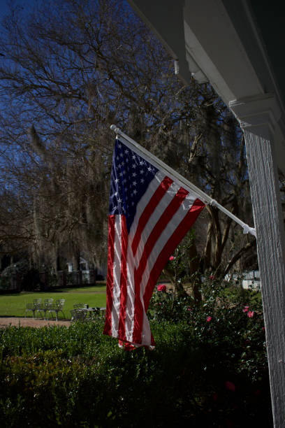 istock American flag outside on a porch pole 1440515749