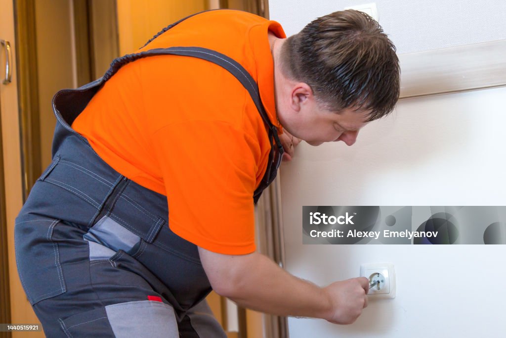 Worker Man Socket A Worker Changes A Faulty Socket In A House Stock Photo - Download ...