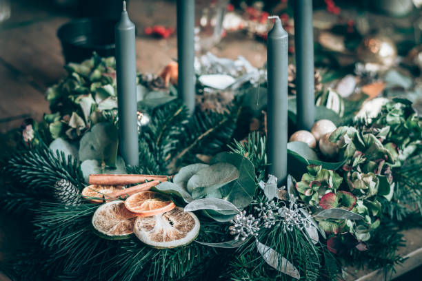 preparing traditional advent wreath with candles, baubles, natural components, pine fir and adorns stock photo