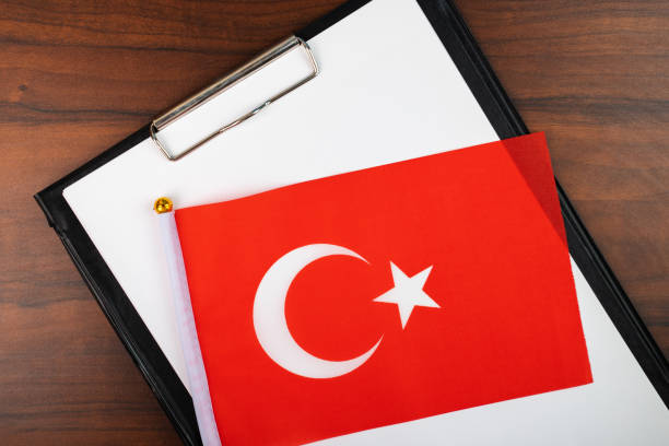 istock mockup for text on clipboard with Turkish flag, white sheet of paper in a folder for notes 1440519240