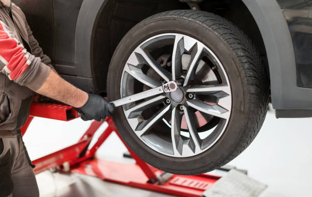 istock Male mechanic using torque wrench on wheel 1440523717