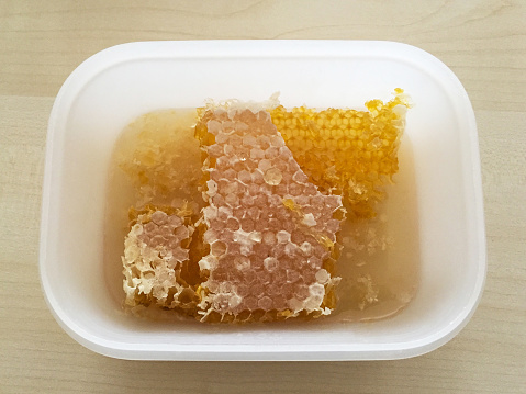 Honey in a plastic box on the table