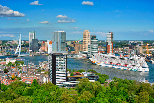 Rotterdam , Netherlands - May 14, 2017: View of Rotterdam city and the Erasmus bridge Erasmusbrug over Nieuwe Maas river with cruise liner from Euromast