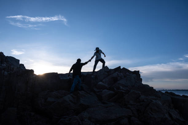 Two men are hiking by the sea