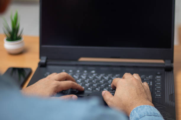 istock man's hands working on laptop at home desk 1440531554