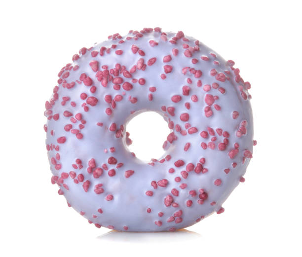 istock Sweet donut with a lilac-colored icing and sprinkle close up on a white isolated background 1440531675