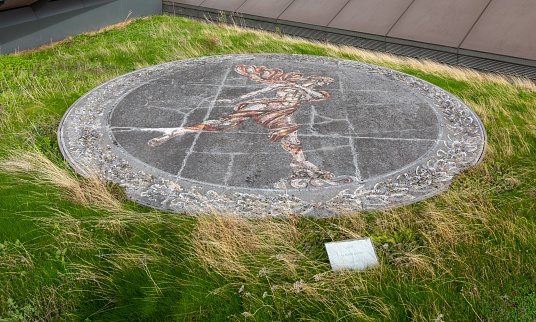 London, United Kingdom – October 28, 2022: A closeup of the Ariel mosaic on the roof of One New Change surrounded by meadow