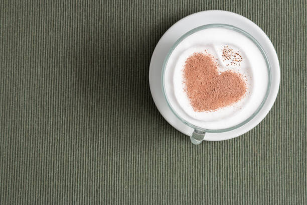 istock Cappuccino cup with a heart shape on the surface on the gray background 1440533467