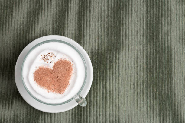 istock Cappuccino cup with a heart shape on the surface on the gray background 1440533490