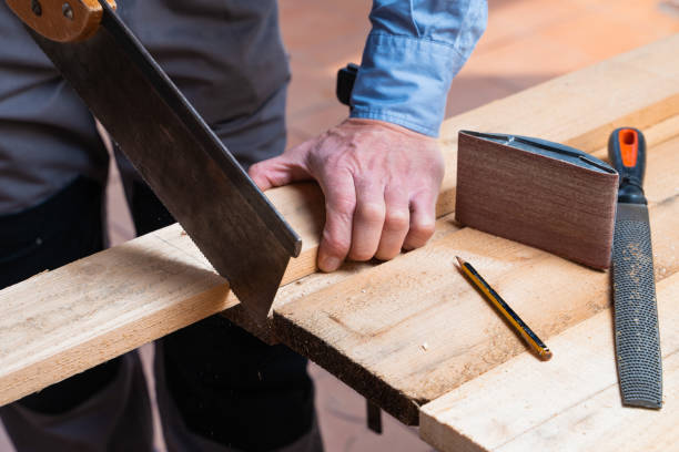istock Carpenter in the process of cutting and making something from wood 1440535868
