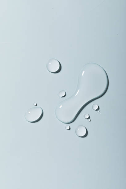 Top vie closeup of multiple waterdrops on a light blue background