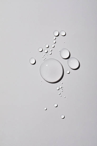 istock Top view closeup of multiple water drops on a light grey background 1440536501