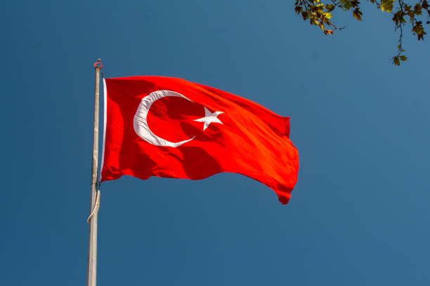 istock National flag with white star and moon on a pole in sky 1440536781
