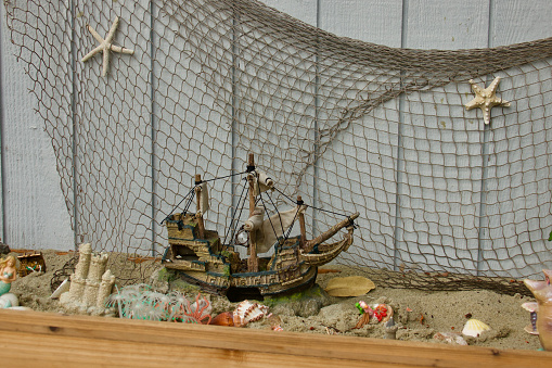 Pirate themed sand box with fishnet and toys
