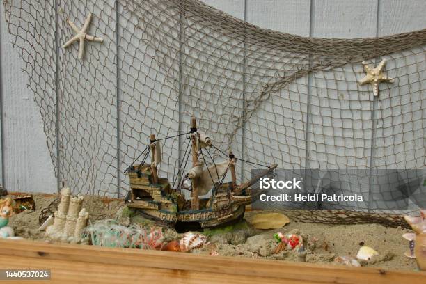 Pirate Themed Sand Box With Fishnet And Toys Stock Photo - Download Image Now - Action Figure, Animal Shell, Backgrounds