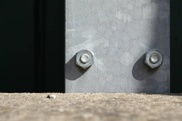 istock Two big screws in a steel plank 1440537047