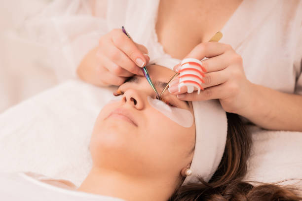 istock Skillful cosmetologist doing lash extension procedure - Beauty concept 1440537180