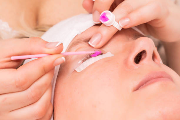 istock Skillful cosmetologist doing lash extension procedure - Beauty concept 1440537193