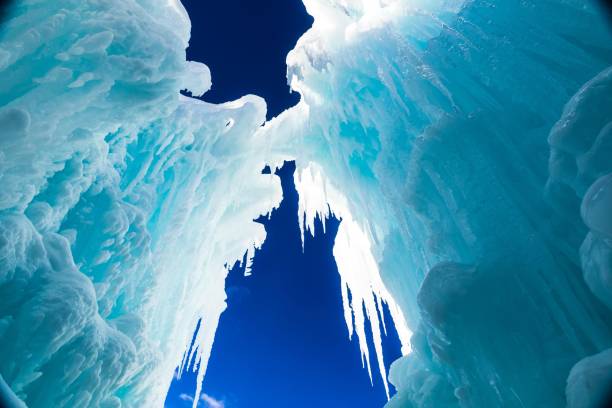istock Low angle of huge ice formations with hanging icicles against the blue clear sky 1440537560