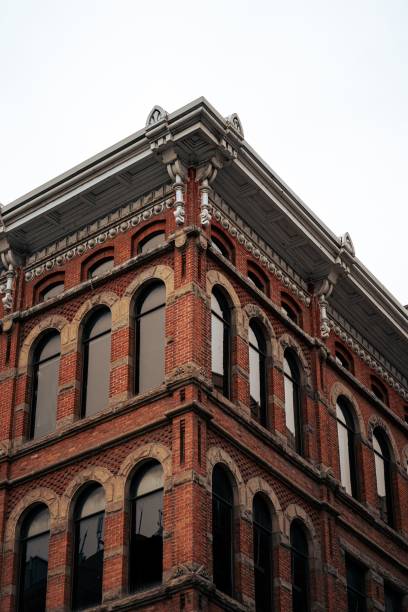 istock Vertical view of a red-tiled building with arc-shaped windows and a beautiful roof 1440537619