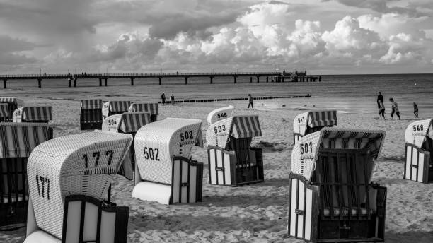 beach chairs against ocean and cloudy sky