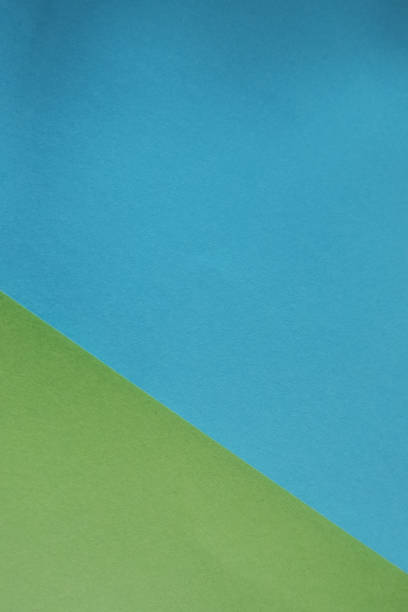 istock Vertical geometric background made with blue and green colored papers - copy space 1440538469