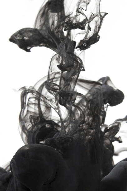 istock Vertical shot of black ink in the water 1440538687