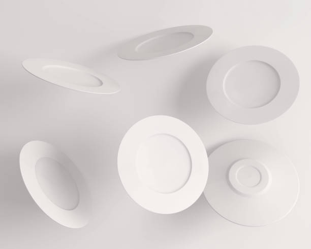 istock Multiple white plates in the air on a white background 1440539628