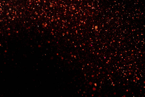 istock Beautiful, sparkling red glitter pouring down from above on a dark background 1440539671