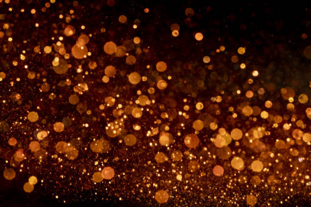 istock Shiny orange bokeh lights on a black background 1440539822