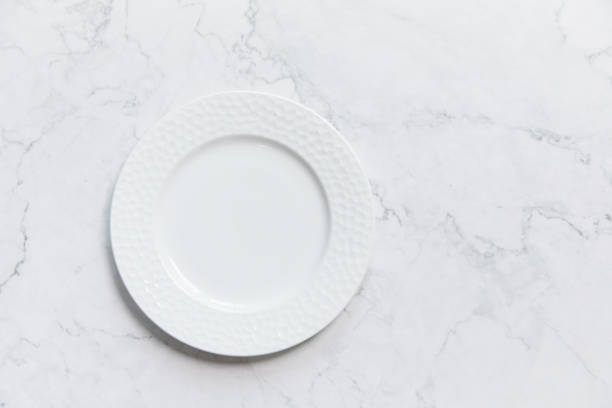 istock Closeup shot of a white plate on a colored background 1440540334