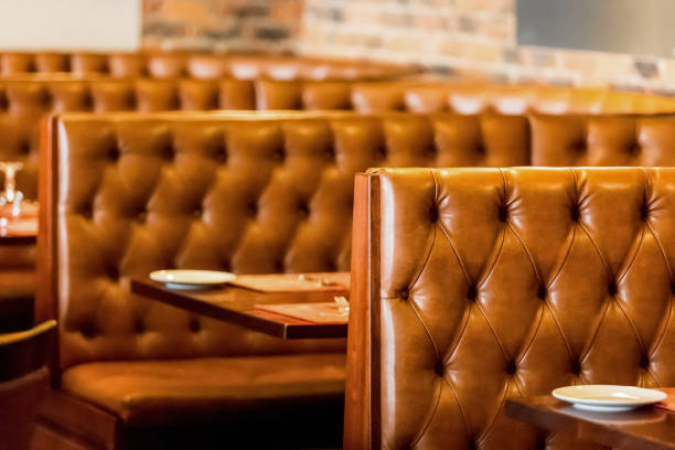 istock Inside of a restaurant with empty leather chairs and tables 1440540885