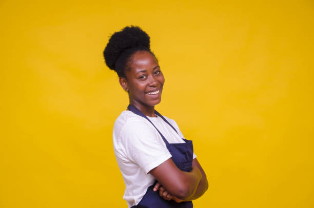 istock Young African-American female posing at camera on yellow background 1440541437