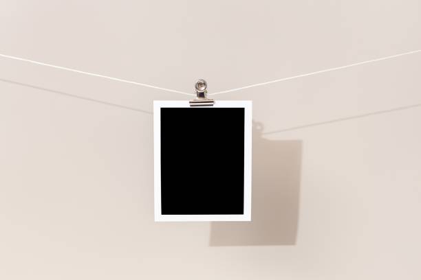istock Blank Vintage instant photo frame hanging on a rope 1440543206