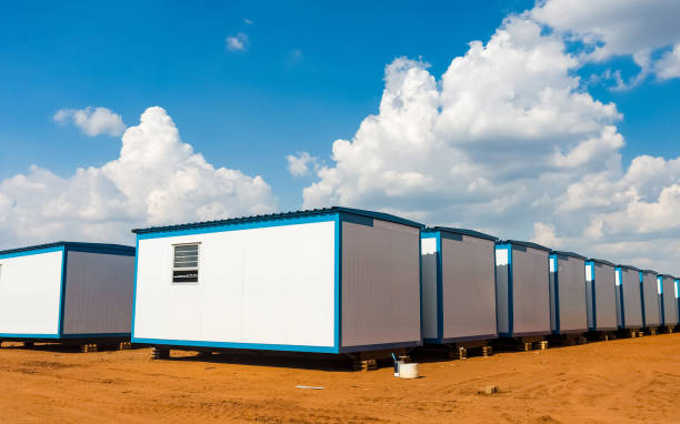 istock Rows of white plastic house boxes under a bright cloudy sky 1440543612
