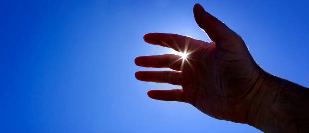 istock Hand Reaching Towards Heaven Seeking Help Sunstar Sunshine Inspiration 1440546239