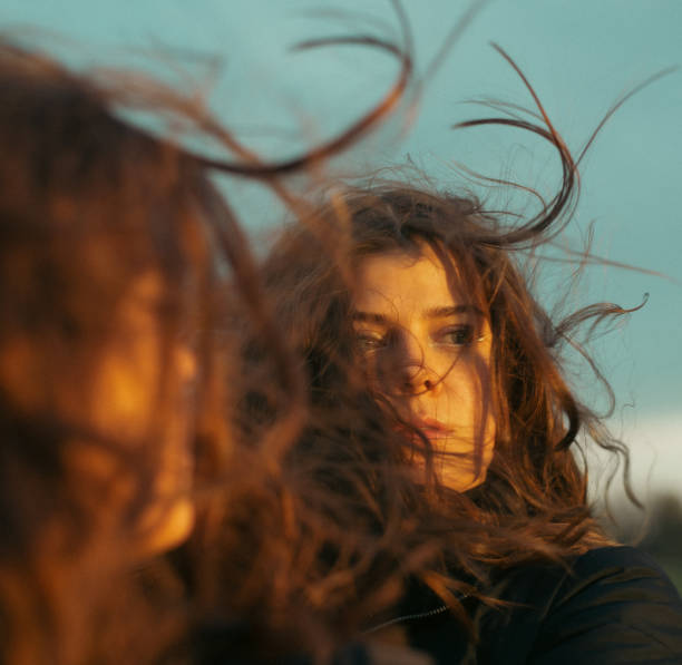Young woman looking in the mirror self reflecting