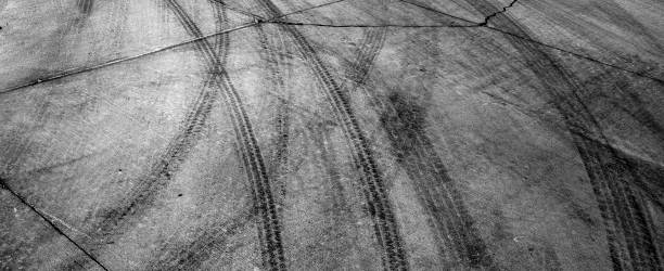 Black Tire Tracks Marks on Cement Drive Black tire tracks or marks from driving on cement drive car burnout stock pictures, royalty-free photos & images