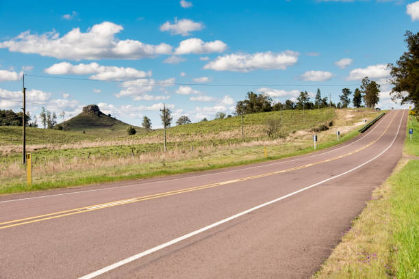 istock Beautiful cloudscape over a paved road going through summer nature scenes 1440546668