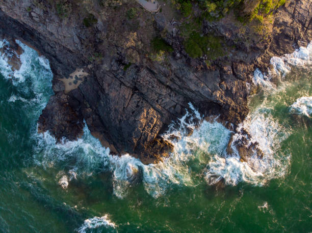 istock Aerial shot of waves hitting a cliff 1440546949