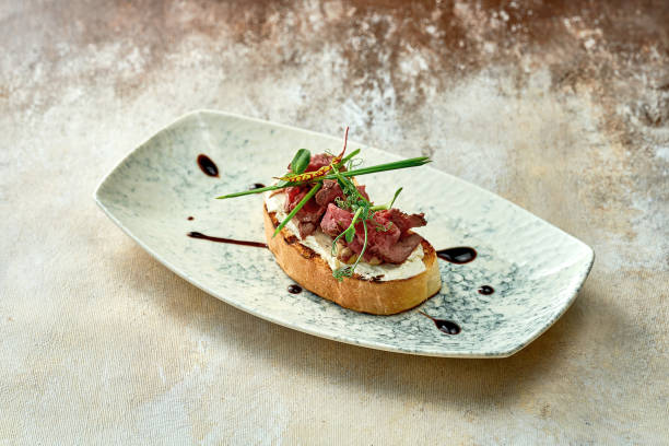 istock Bruschetta with roast beef in a plate. Close-up, selective focus 1440547324