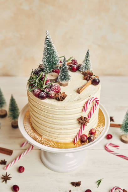 istock Vertical shot of a Christmas cake decorated with trees and candy sticks 1440547647