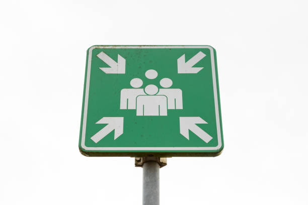 istock Emergency evacuation assembly point sign on a pole on a white background 1440548451