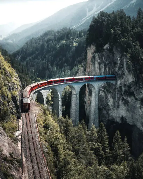 A Swiss train ridin over the Landwasser Viaduct near Filisur, Canton of Grisons, Switzerland