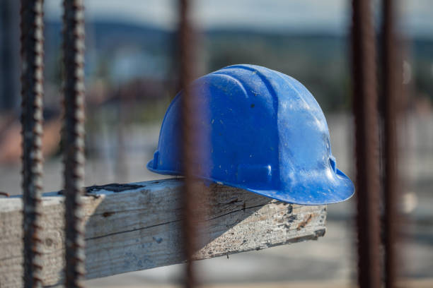 istock Selective focus shot of the blue construction safety helmet at a construction site 1440548912